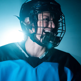 Renata Fast portrait smiling in hockey gear
