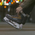 lacing up a pair of brown and tan ice skates